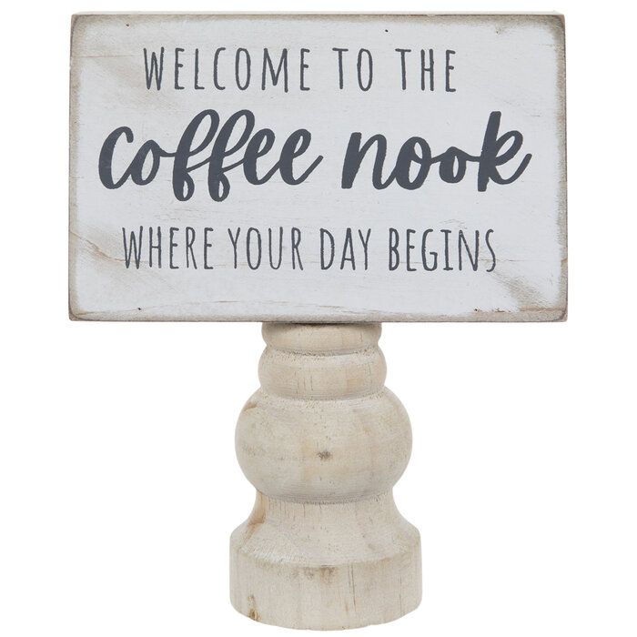 a sign that says welcome to the coffee nook where your day begins