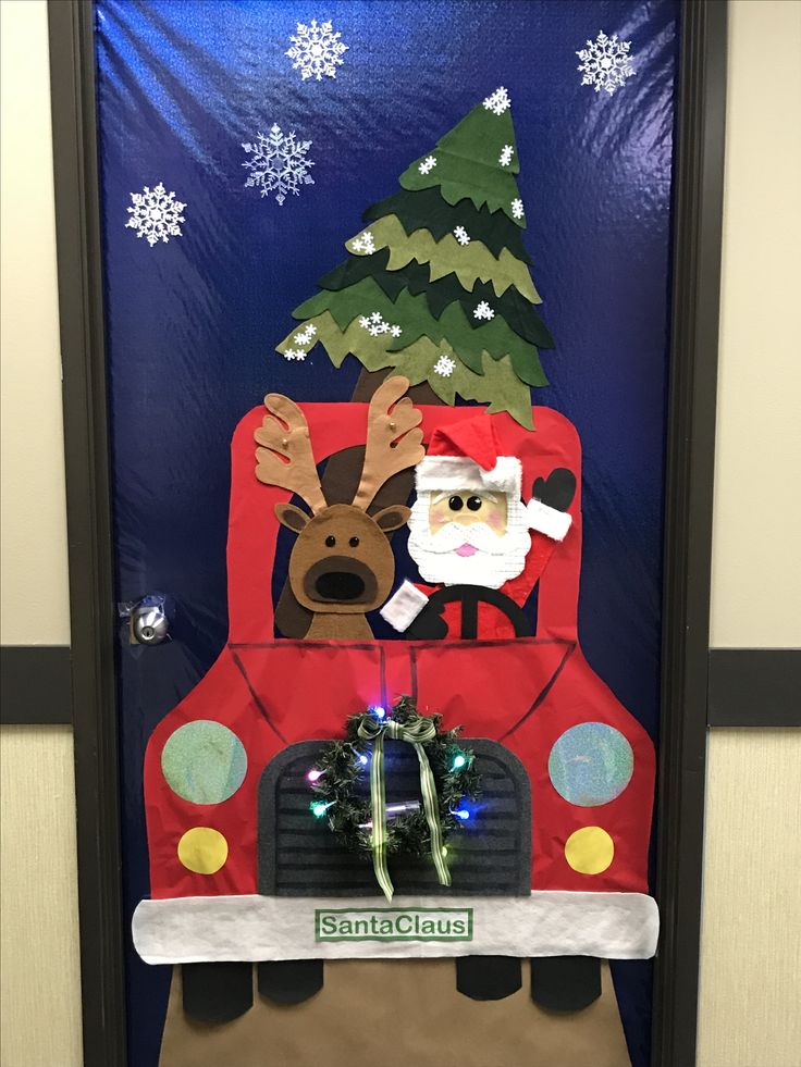 a door decorated to look like a truck with santa clause on it and a christmas tree in the back