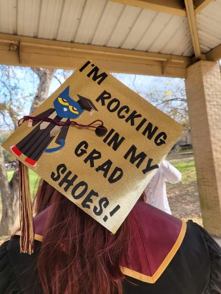 a woman wearing a graduation cap that says i'm rocking in my grad shoes