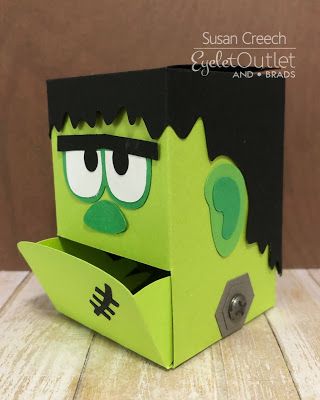 a paper box with a green monster face on it