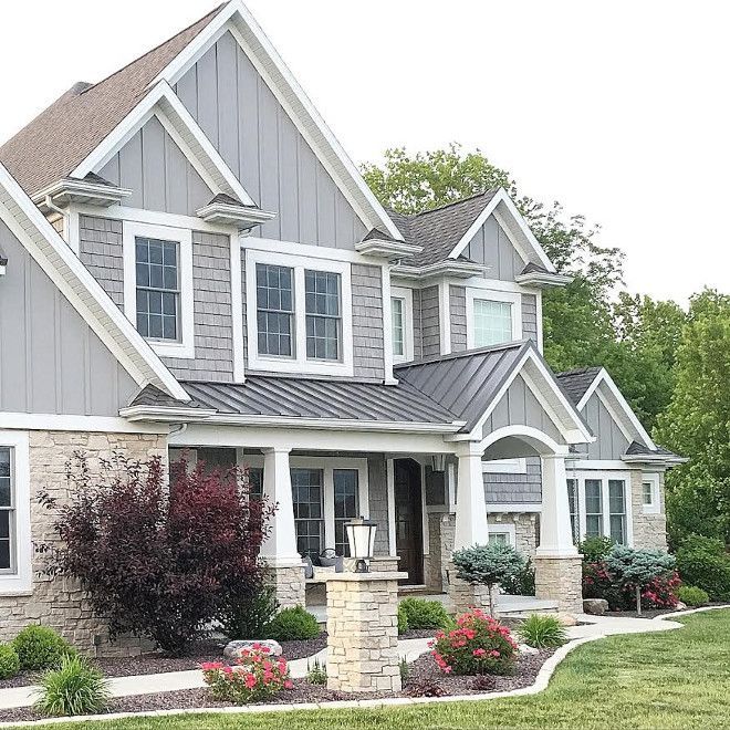 a large gray house with white trim and windows