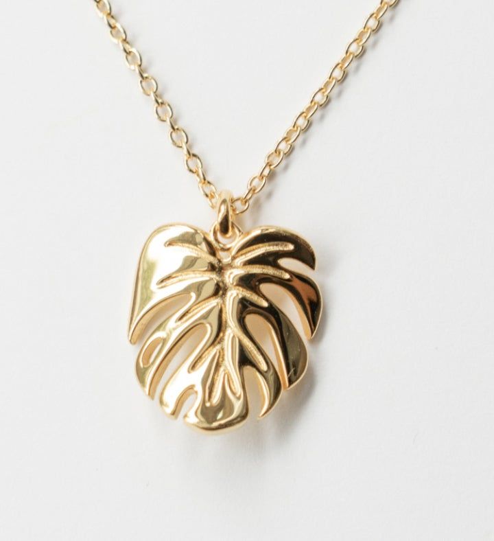 Inspired by my very own Monstera deliciosa, this gorgeous Monstera Deliciosa leaf necklace is plated in White Gold and has a Mirror- like finish. This is a stunning necklace that makes the perfect gift the nature enthusiast. | Inspired by my very own Monstera deliciosa, this gorgeous Monstera Deliciosa leaf necklace is plated in White Gold and has a Mirror- like finish. This is a stunning necklace that makes the perfect gift the nature enthusiast. | 1-800-Flowers Gifts Delivery Monstera Delicios Leaf-shaped Yellow Gold Necklace, Yellow Gold Leaf Necklace As Gift, Leaf-shaped Yellow Gold Necklace For Gift, Yellow Gold Leaf Necklace For Gift, Gold Leaf-shaped Jewelry Gift, Gold Plated Leaf-shaped Jewelry For Gifts, Leaf-shaped Yellow Gold Plated Jewelry, Yellow Gold Plated Leaf-shaped Jewelry, Gold Plated Leaf-shaped Jewelry