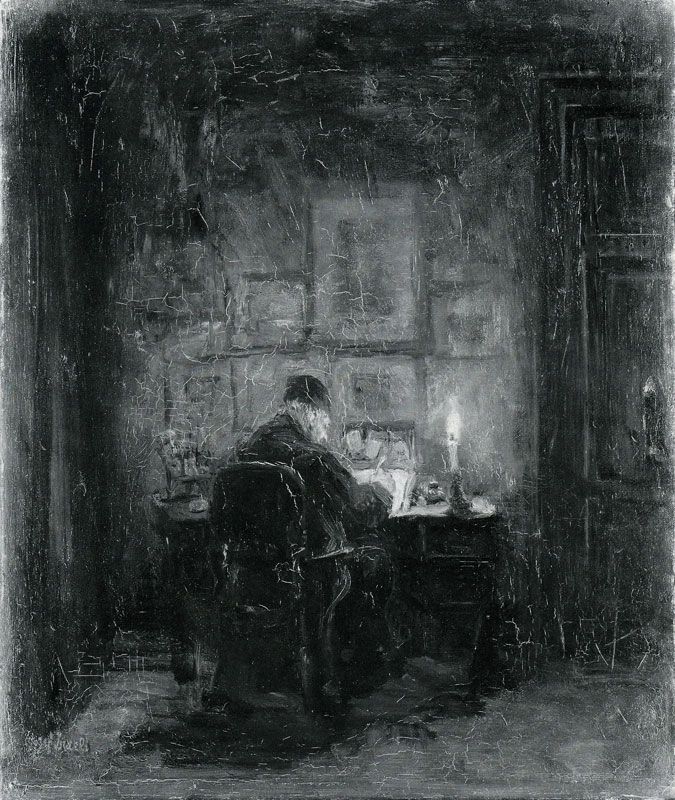 a man sitting at a desk in front of a window with a lit candle on it