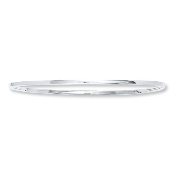 Worn alone or with several other bracelets, this polished sterling silver bangle bracelet is a fashion jewelry must-have. Stackable Sterling Silver Bangle In White Gold, Stackable Sterling Silver White Gold Bangle, Stackable White Gold Sterling Silver Bangle, Everyday Sterling Silver Bangle, Classic Cuff Bracelet With Sterling Silver Clasp, Classic Silver Stackable Bracelets, Classic White Gold Bangle With Sterling Silver Clasp, Classic Silver Round Band Bracelet, Classic Silver Bracelet