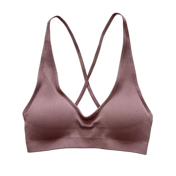 Experience style and comfort in one package with the Mauve Seamless Ribbed Cross Back Bralette. This chic bralette, perfect for both loungewear and sports purposes, promises unrivaled comfort and flexibility. Made with soft, ribbed fabric that hugs your curves, it showcases a stylish cross-back design that guarantees support and a free range of motion. Whether you're studying, working out, or just lounging around, this bralette can keep up with your busy schedule. It's naturally breathable, ensu