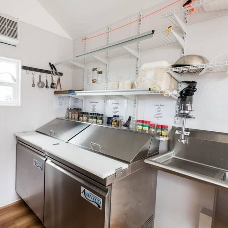 a commercial kitchen with stainless steel appliances and shelves