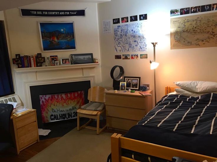 a bedroom with a fire place, desk and bed