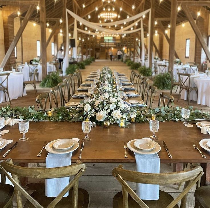 the tables are set with place settings and flowers on them for an elegant wedding reception