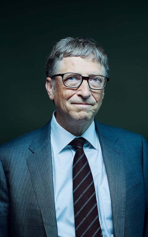 an older man wearing glasses and a suit