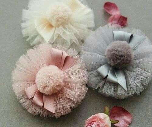 three different types of hair clips with flowers on them