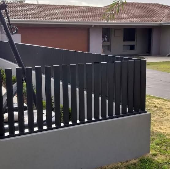 a metal fence in front of a house