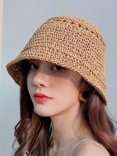 a woman wearing a straw hat with long hair