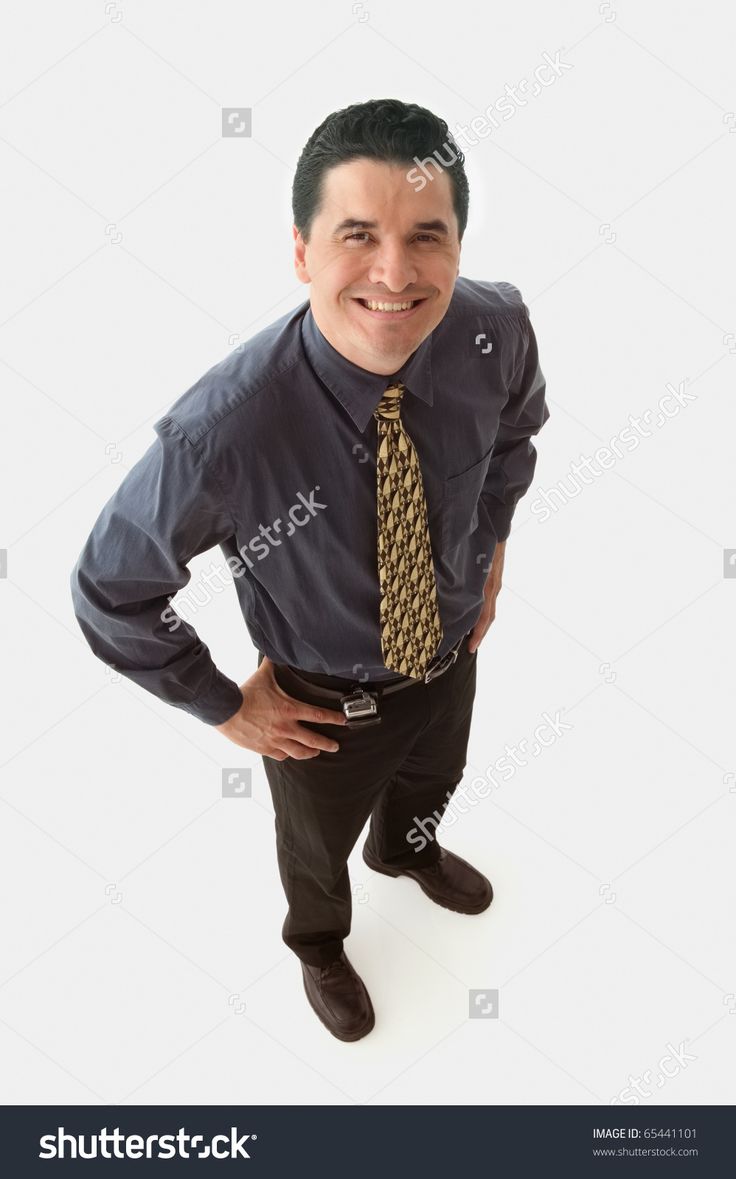 an overhead view of a man wearing a dress shirt and tie with his hands on his hips