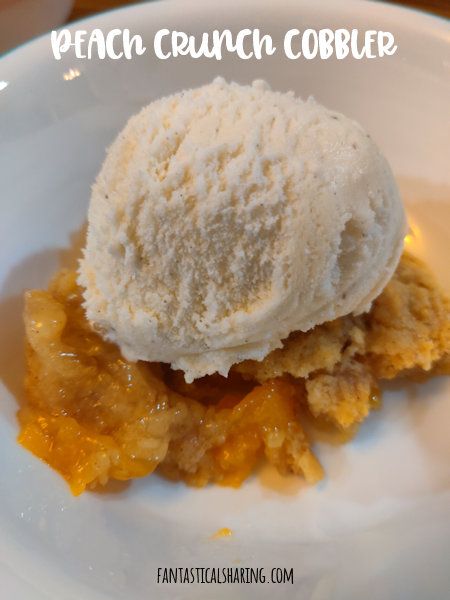 a white plate topped with a scoop of ice cream next to an orange cobble