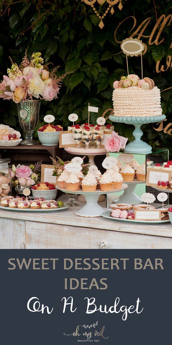 sweet dessert bar with cakes and cupcakes on it for an outdoor wedding reception