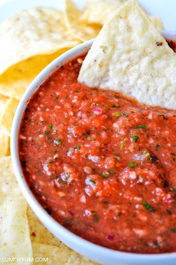 a white bowl filled with salsa and tortilla chips