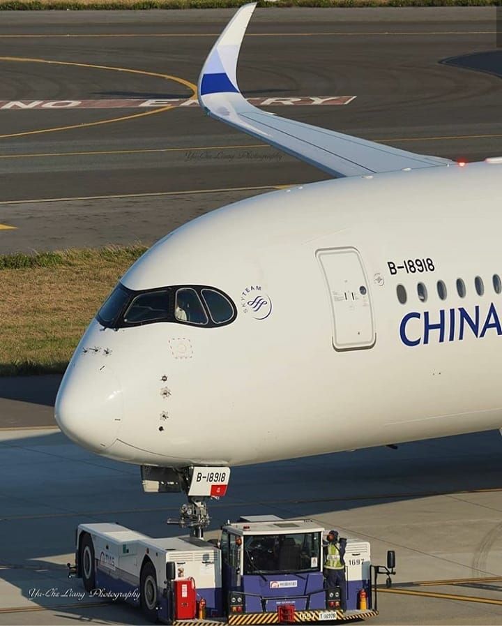 an airplane is parked on the tarmac with its luggage cart pulled up to it