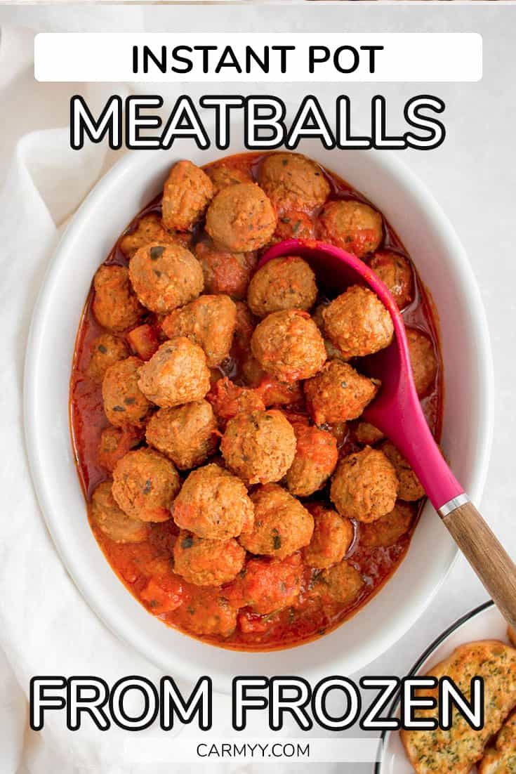 a white bowl filled with meatballs next to crackers and a pink spatula