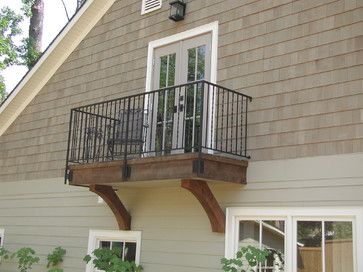 a house with two windows and a balcony