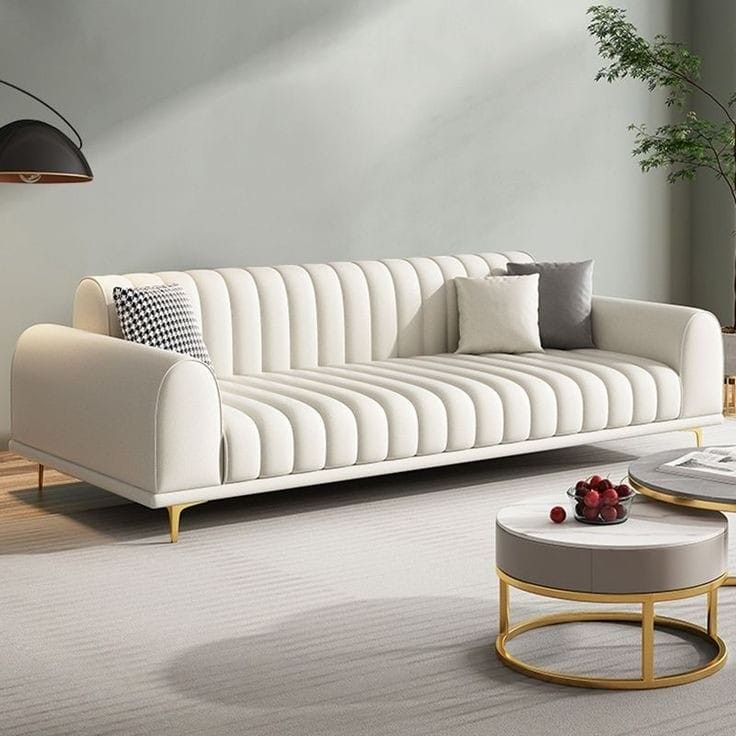 a living room with white couches and coffee table