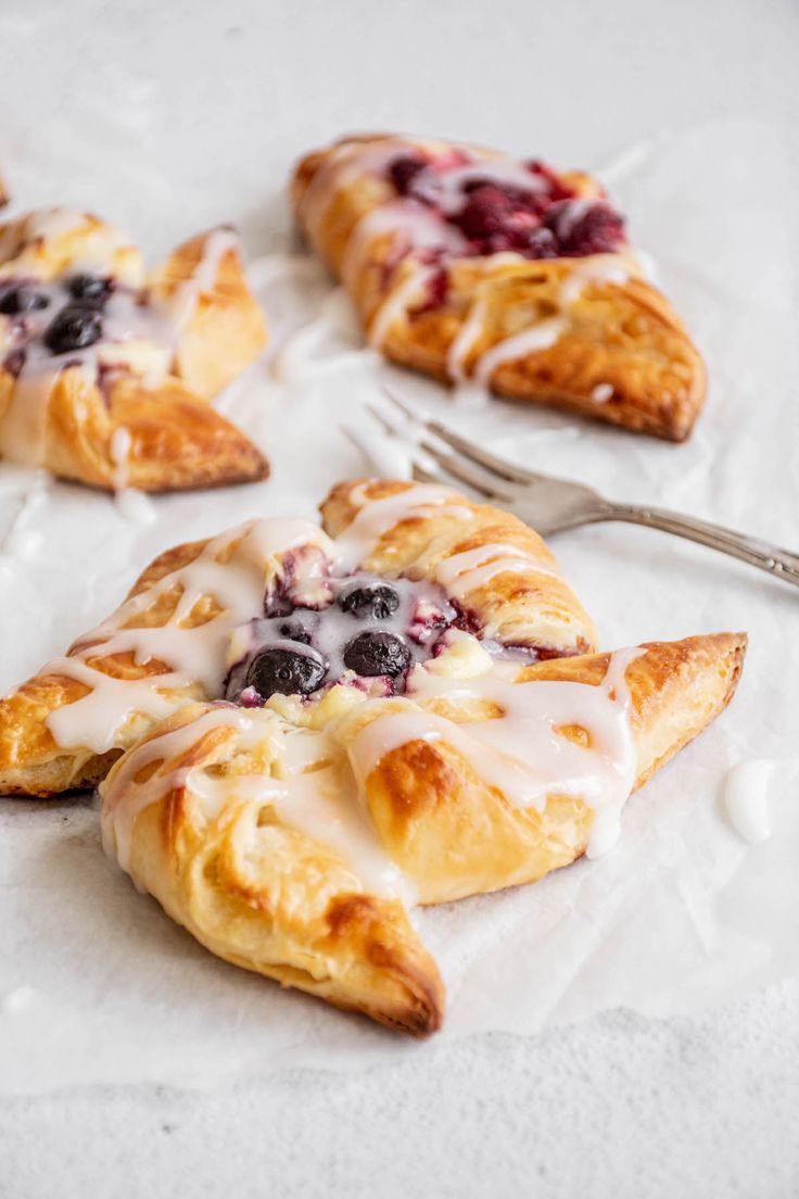 blueberry danish pastries on parchment paper with fork