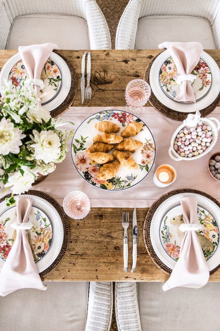 an overhead view of a table set with flowers and plates