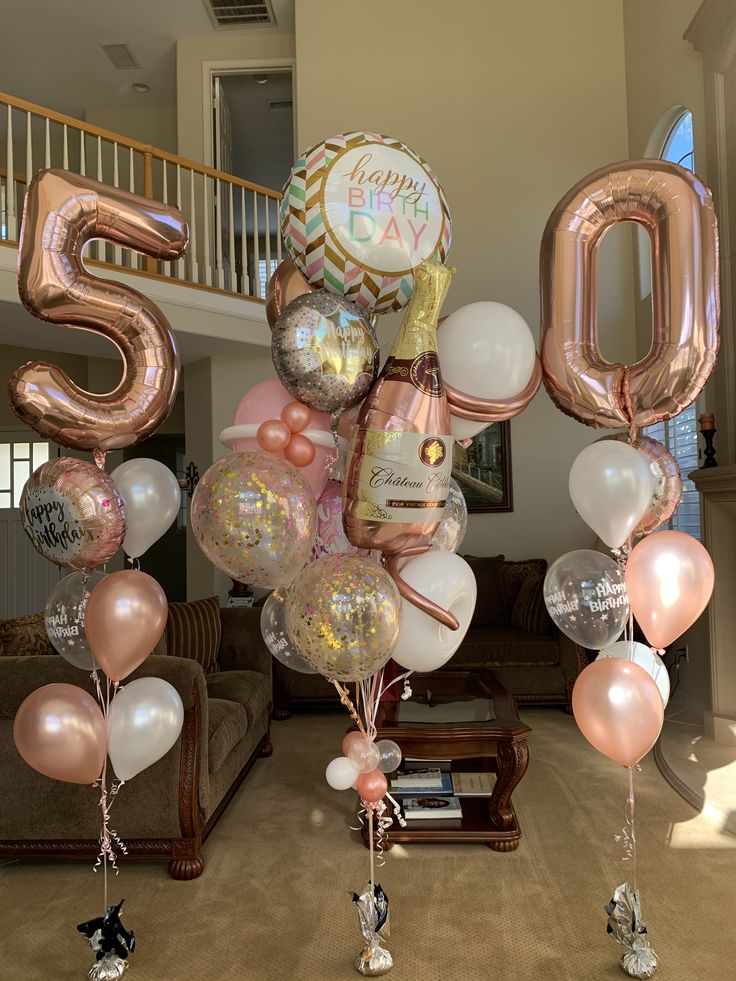 balloons and streamers are arranged in the shape of numbers for a 50th birthday party