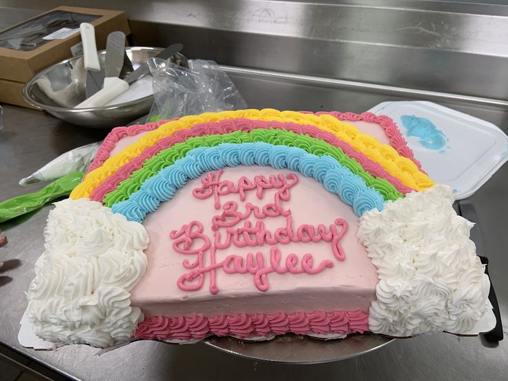 a birthday cake with rainbow frosting on it