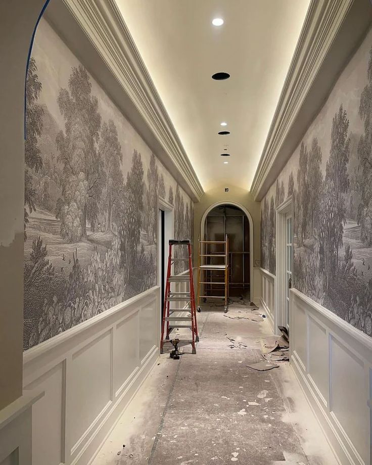 an empty hallway with wallpapered walls and scaffolding on the floor in front of it