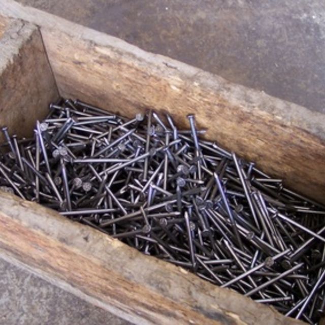 a wooden box filled with lots of nails