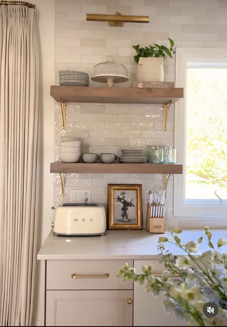 a kitchen with open shelving and white walls