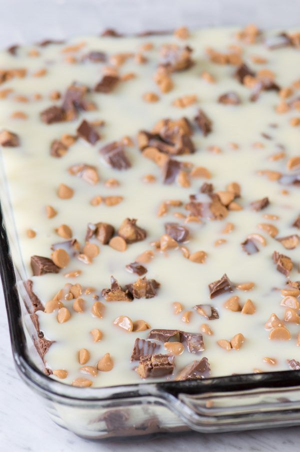 a pan filled with chocolate and nuts on top of a table