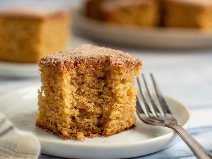 a close up of a piece of cake on a plate with a fork near by