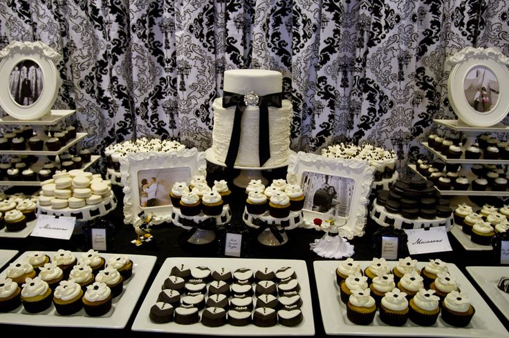 a table topped with lots of cupcakes and cakes