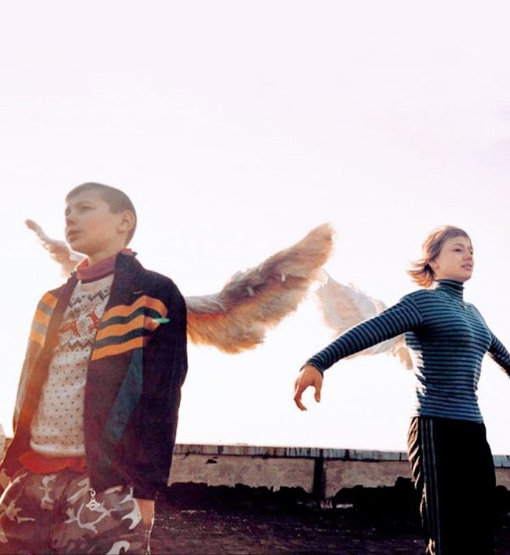 two people standing next to each other with wings