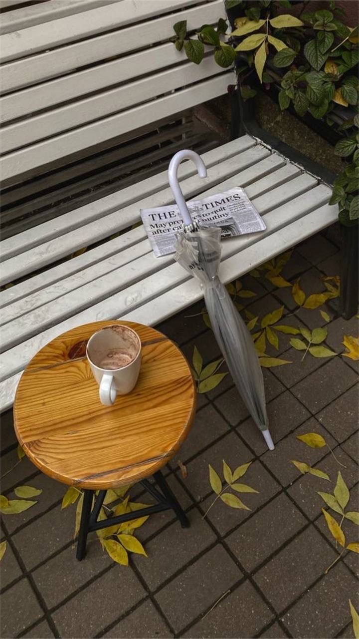 an umbrella and coffee cup on a wooden table