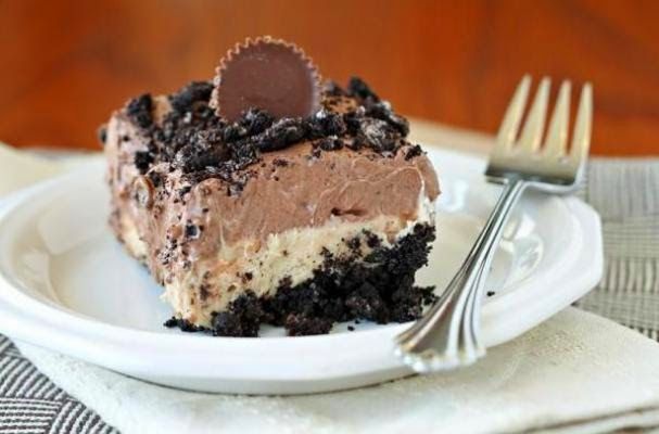 a piece of chocolate peanut butter no bake dessert on a plate with a fork