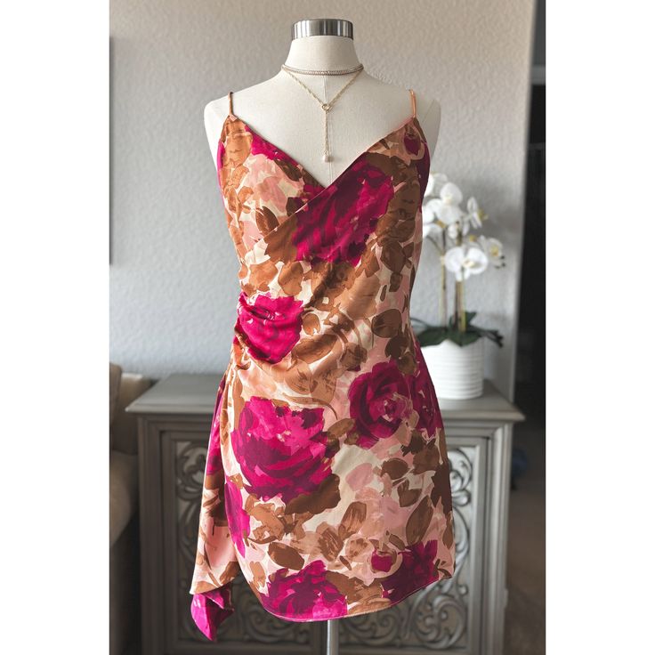 Step Into Elegance With Our Women's Floral Ruched Side Dress, A Perfect Blend Of Femininity, Romance, And Sophistication. This Stunning Dress Features A Flattering Ruched Side Design That Hugs Your Curves In All The Right Places, Creating A Silhouette That's Both Elegant And Alluring. The Dress Showcases A Beautiful Floral Print In Rich Hues Of Pink And Brown, Making It A Standout Piece For Any Special Occasion. The Adjustable Straps And Back Zipper Closure With A Hook And Eye Ensure A Perfect F Satin Floral Print Dress For Night Out, Fitted Satin Dress With Floral Print, Satin Floral Print Mini Dress For Brunch, Floral Print Satin Mini Dress For Brunch, Satin V-neck Dress For Garden Party, Fitted Satin Mini Dress For Garden Party, Fitted Floral Dress Lined For Party, Fitted Floral Dress For Party, Lined, Fitted Floral Party Dress With Lining