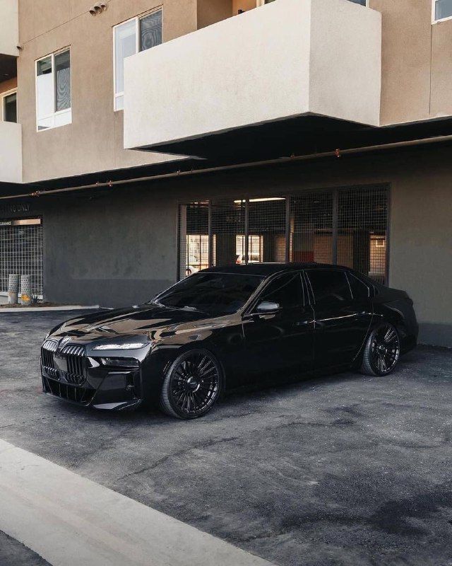 a black car parked in front of a building