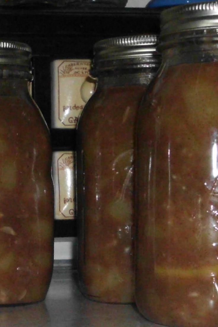 three jars filled with food sitting on top of a counter