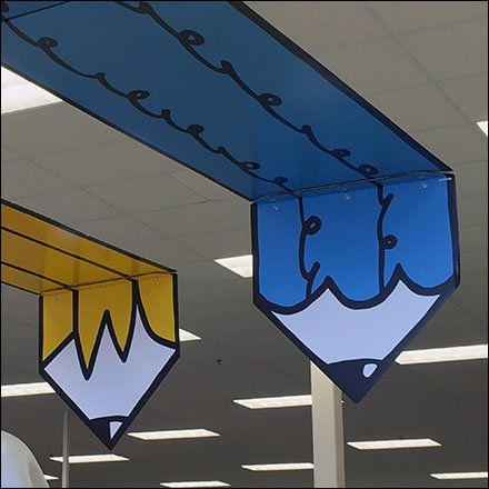 two blue and yellow signs hanging from the ceiling