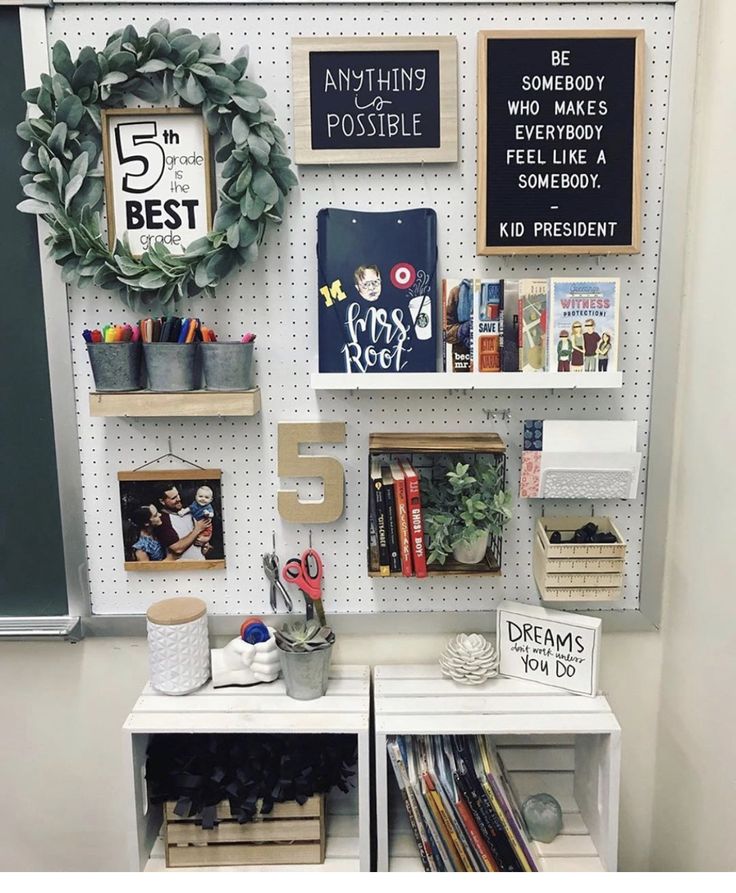 two shelves with books, magazines and other items on them in front of a bulletin board