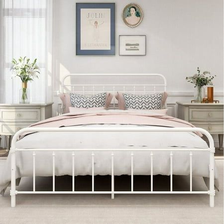 a white metal bed frame in a bedroom