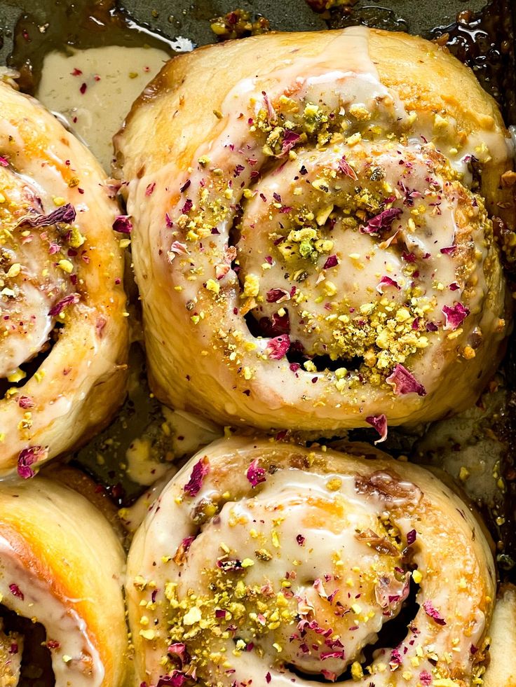 there are many rolls with sprinkles on them in the baking pan together