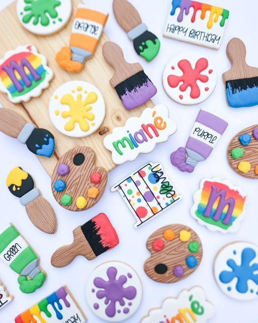 a bunch of decorated cookies sitting on top of a table