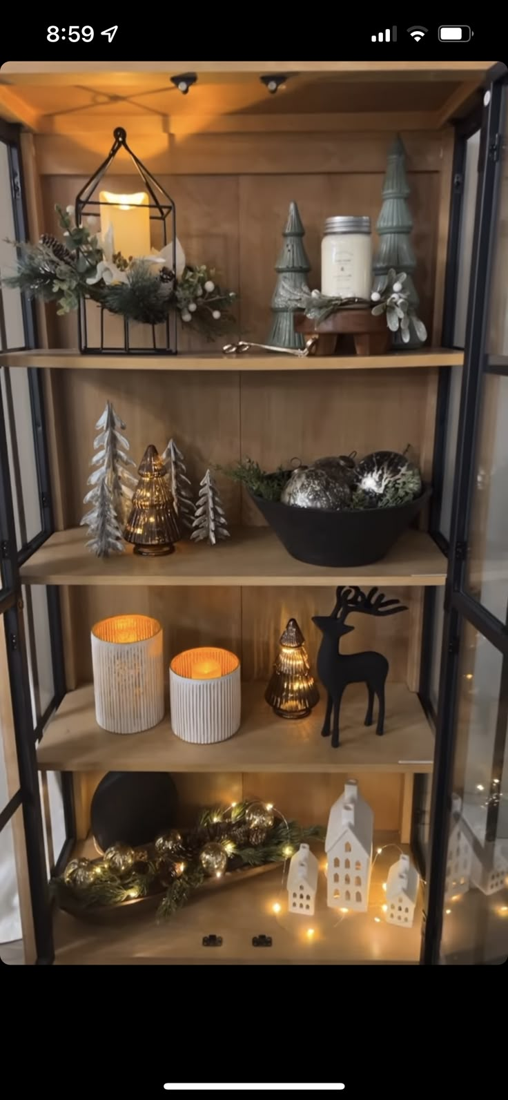 a shelf with candles and other decorations on it