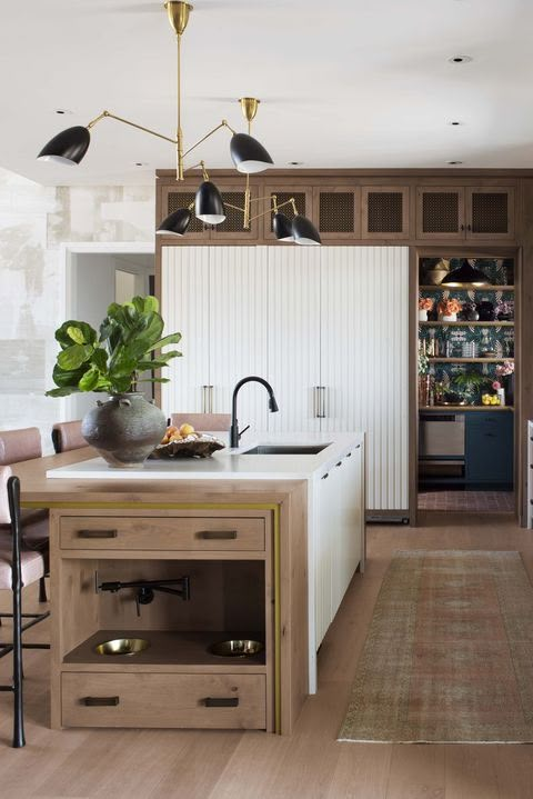 a kitchen with an island, sink and cabinets in it's center area is shown