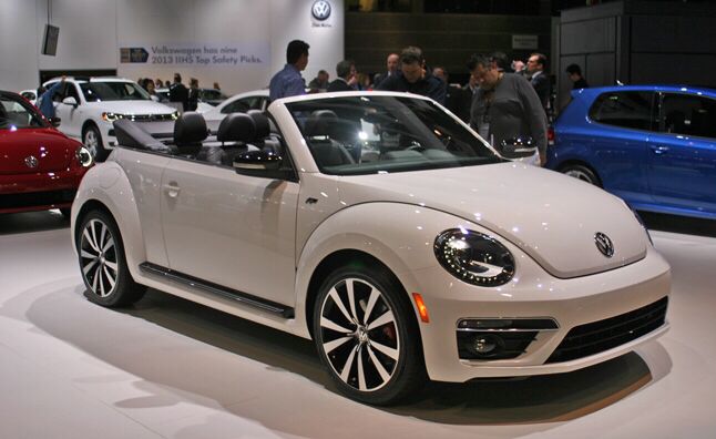 the volkswagen beetle convertible is on display at an auto show