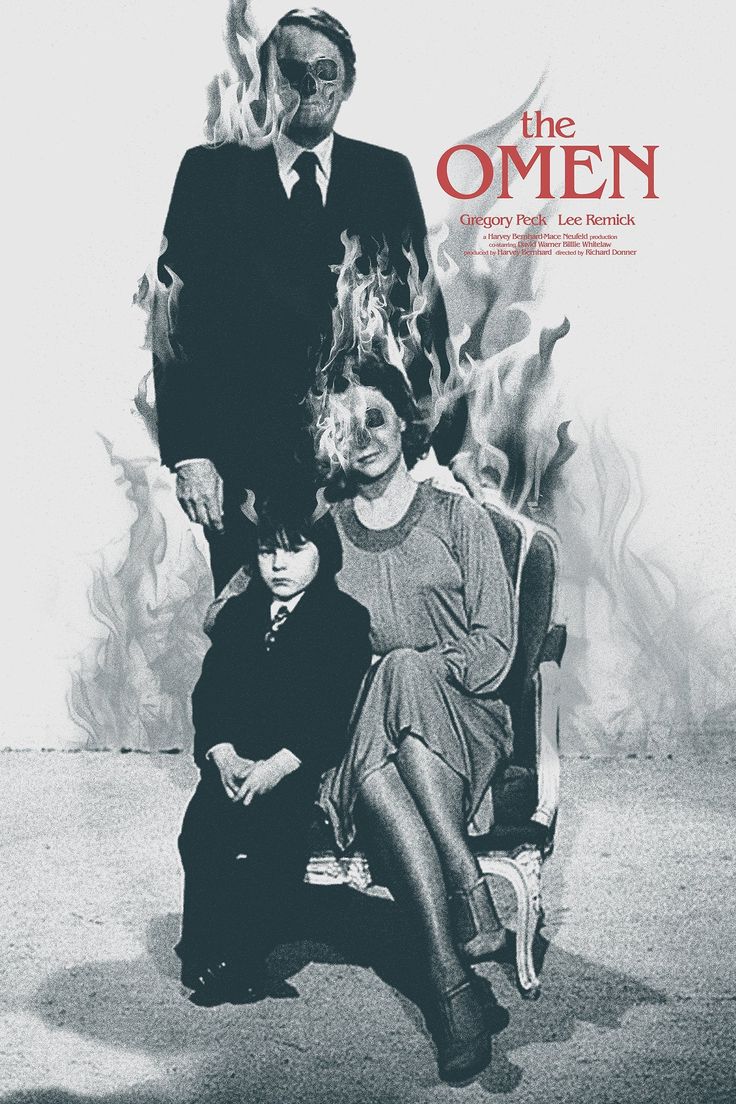 the omen movie poster with two people sitting on a chair in front of them