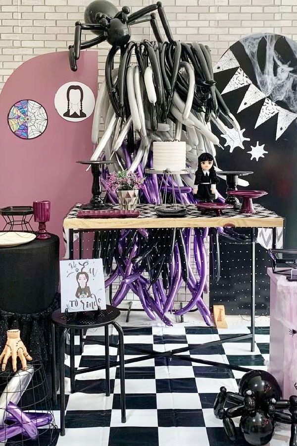 a table with purple and black decorations on it